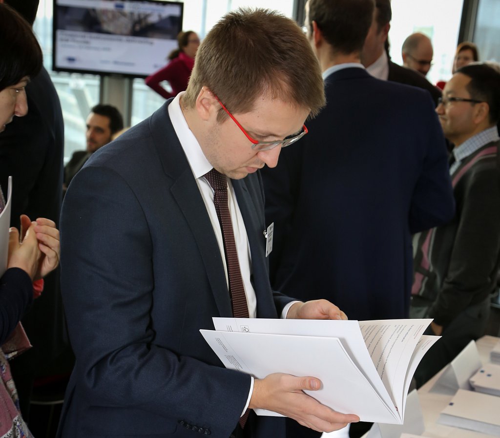 Event participant reading a fi-compass publication
