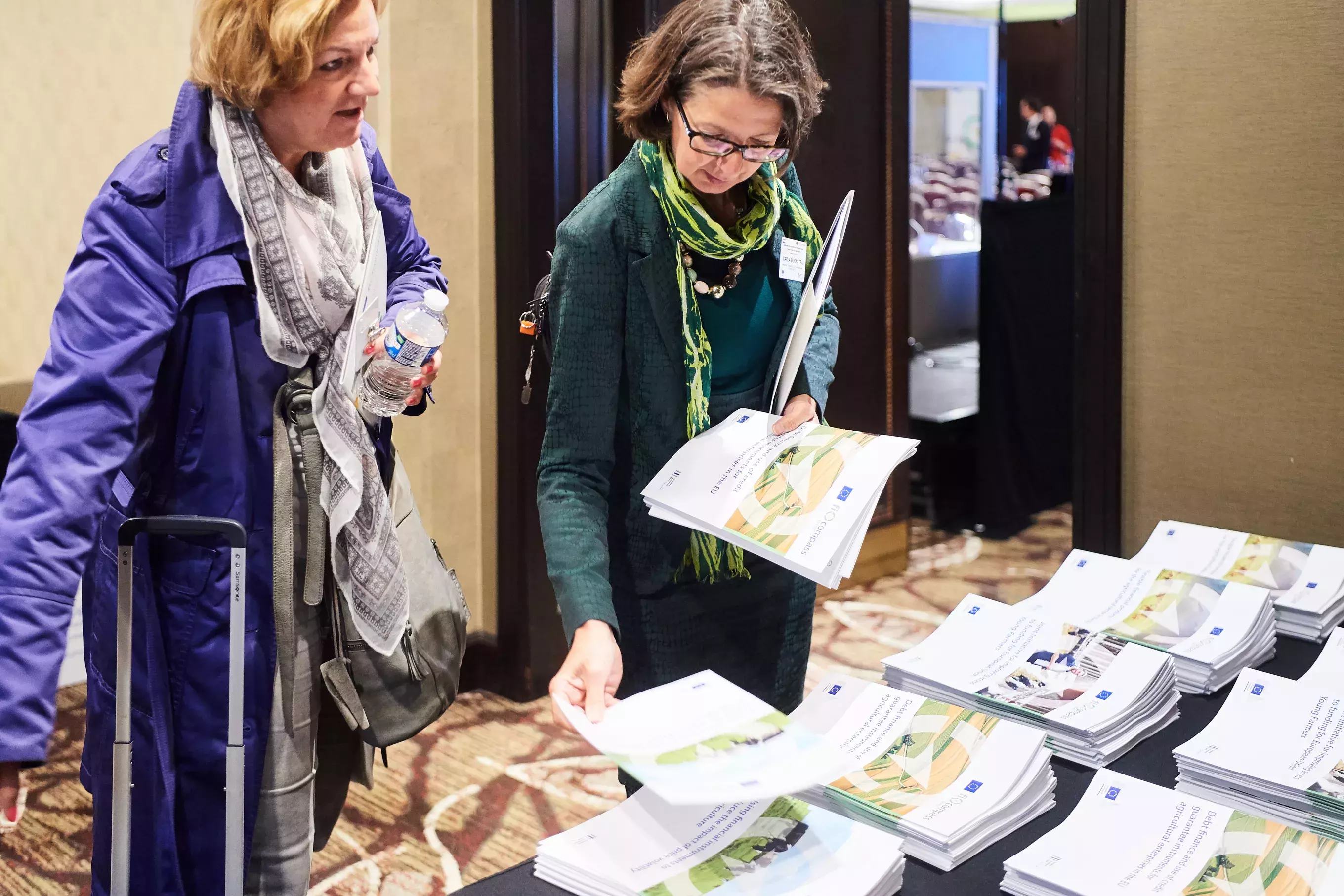 Event participant selecting fi-compass publications