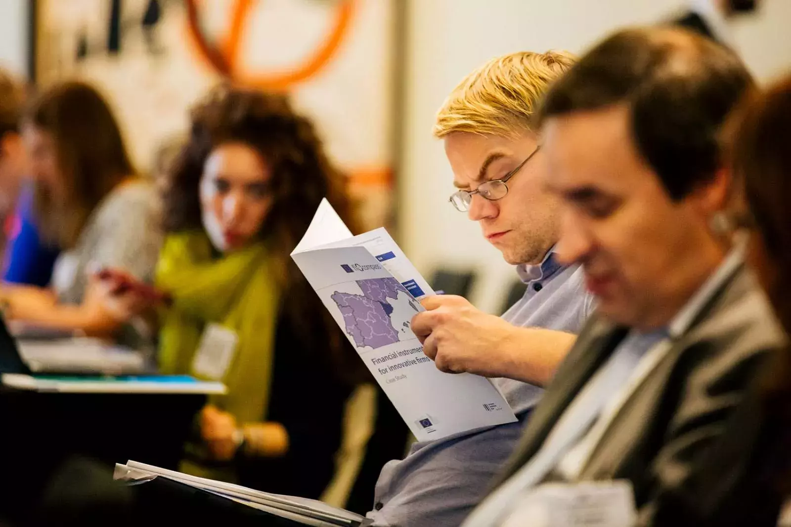 Event participant reading a fi-compass case study