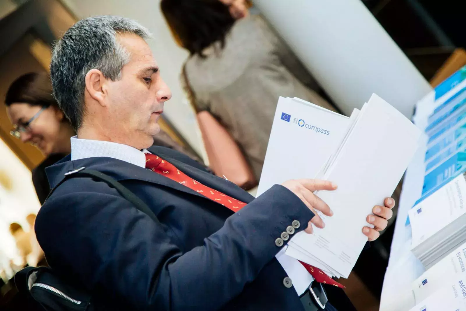 Event participant selecting fi-compass publications