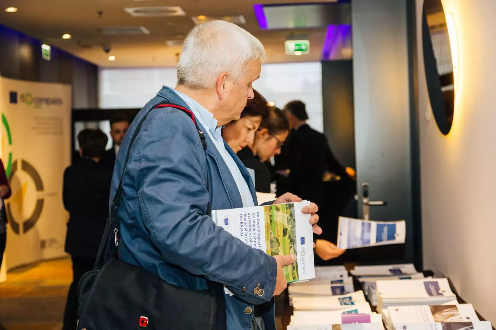 Event participant selecting fi-compass publications