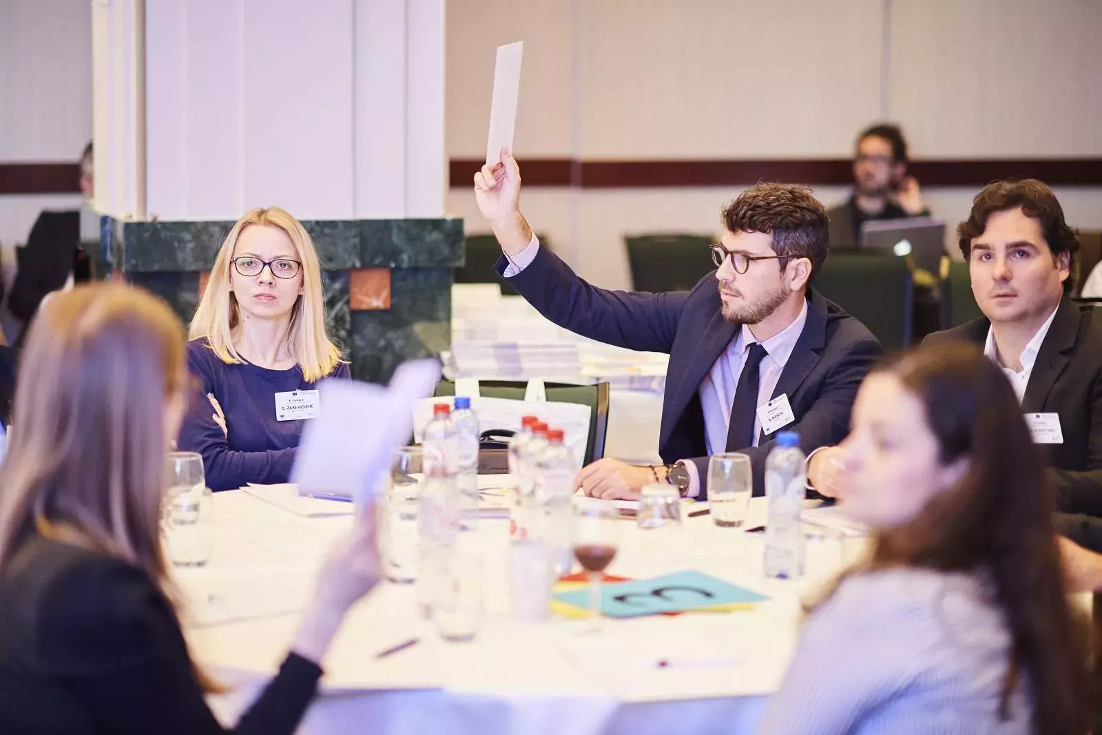 Participants discussing correct brain teaser solutions in groups