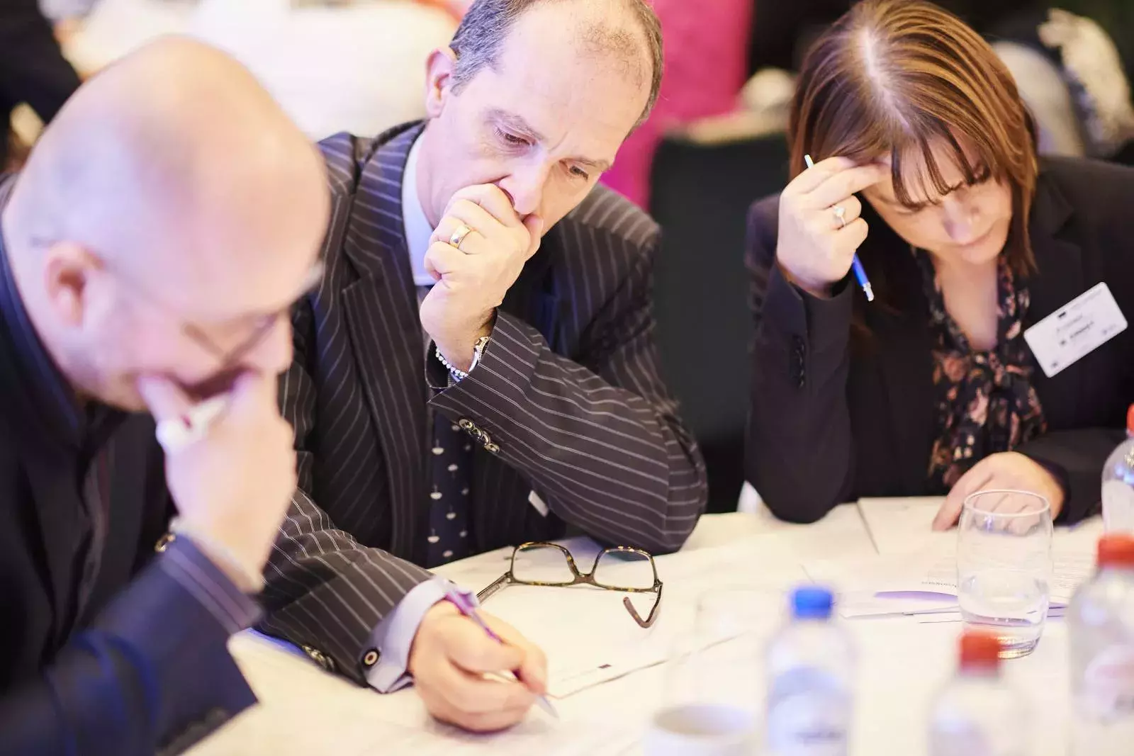 Participants working in groups on brain teasers