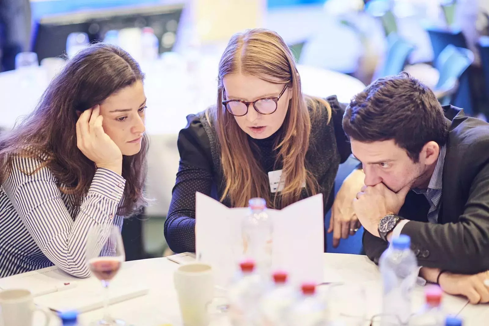 Participants working in groups on brain teasers