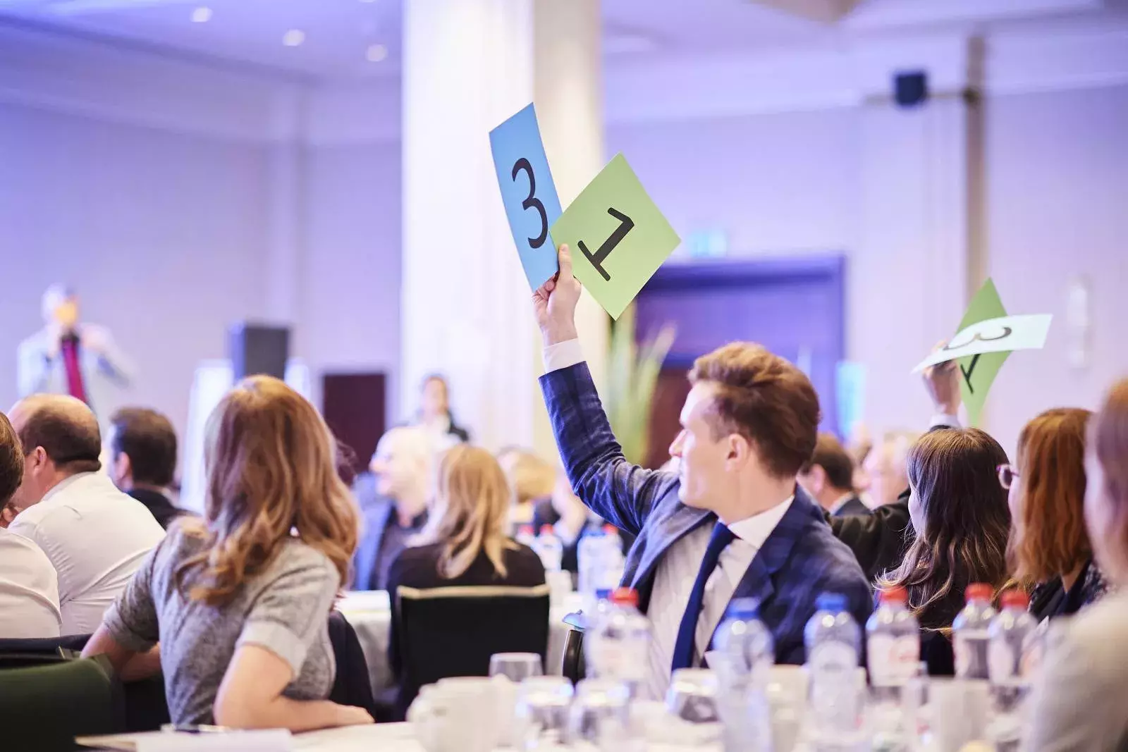 Participants working in groups on brain teasers