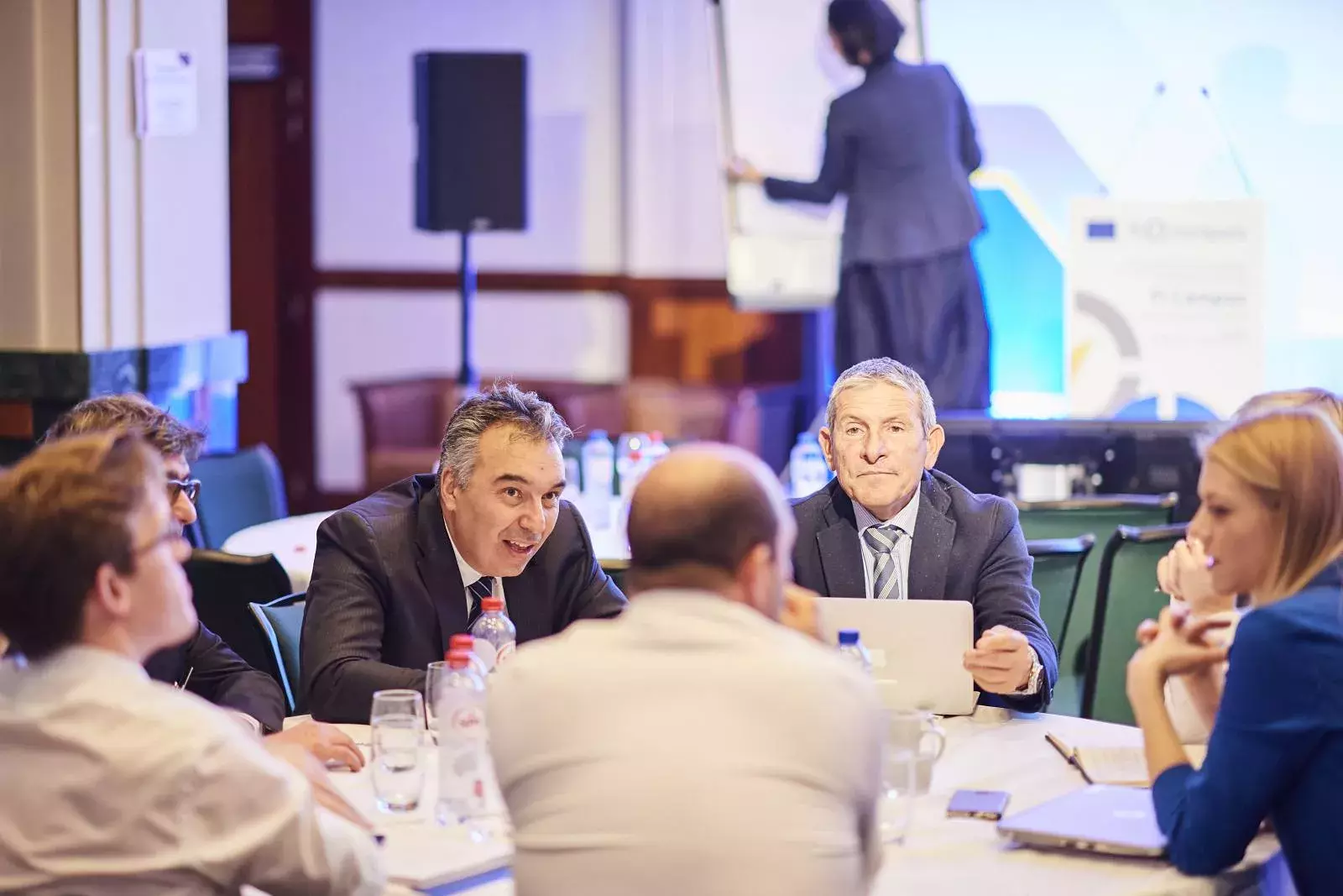 Participants working in groups on brain teasers