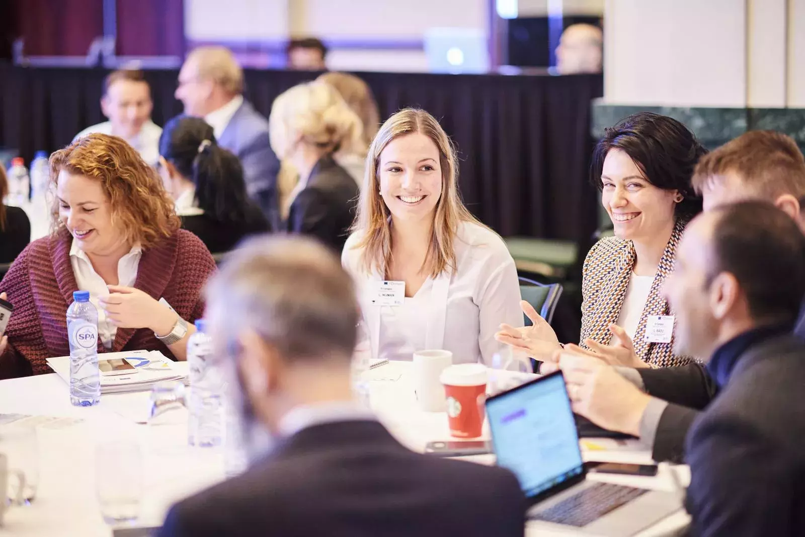 Participants working in groups on brain teasers