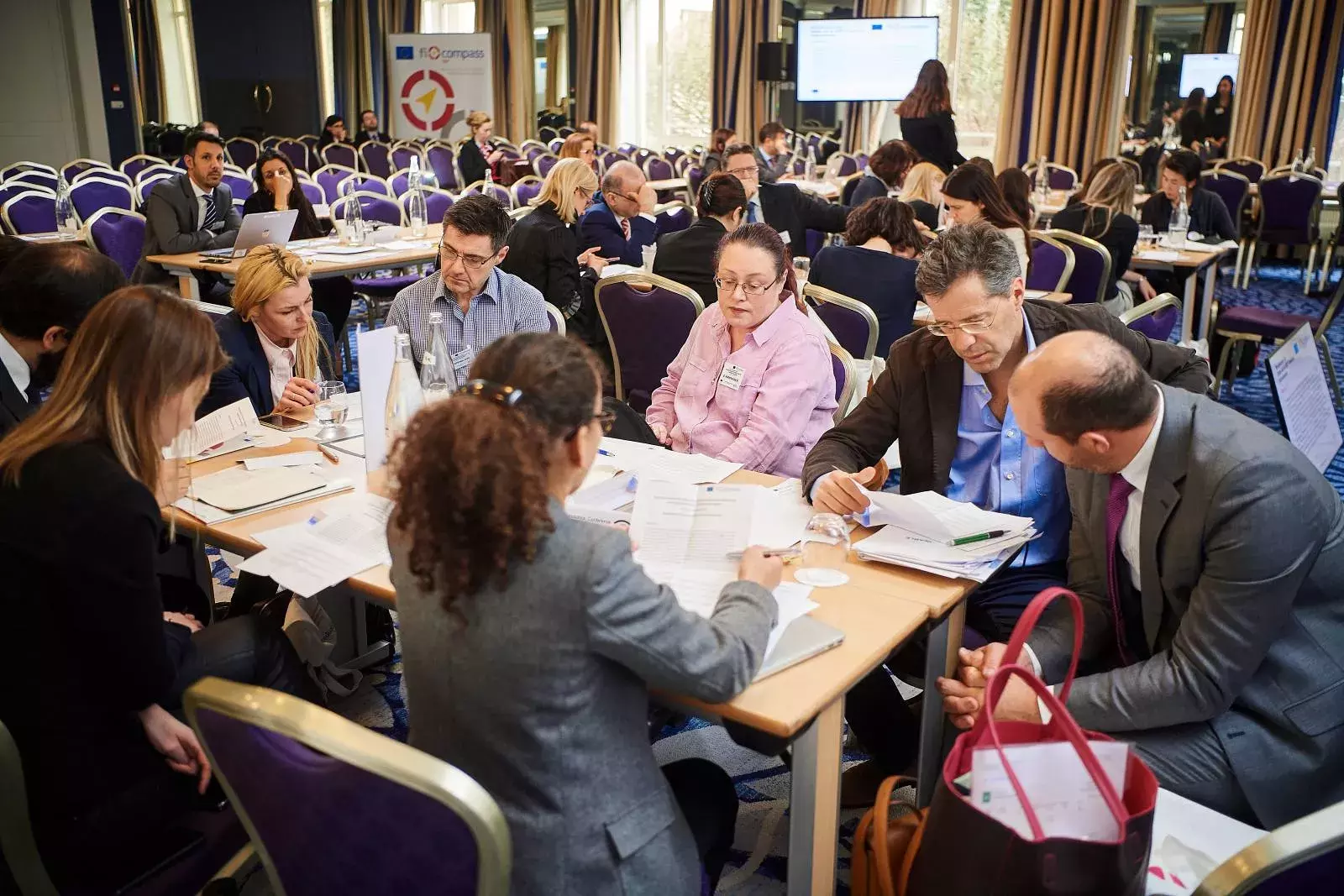 Participants working in groups on brainteasers
