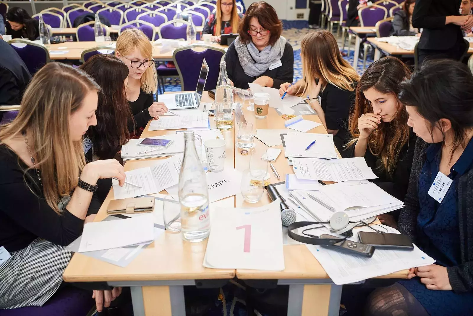 Participants working in groups on brainteasers