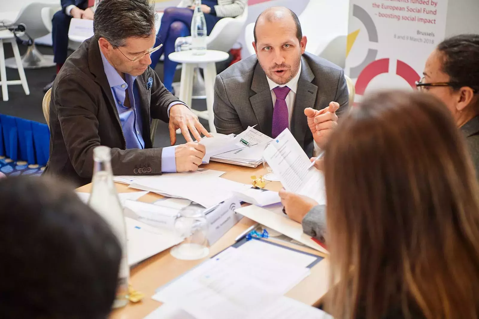 Participants working in groups on brainteasers