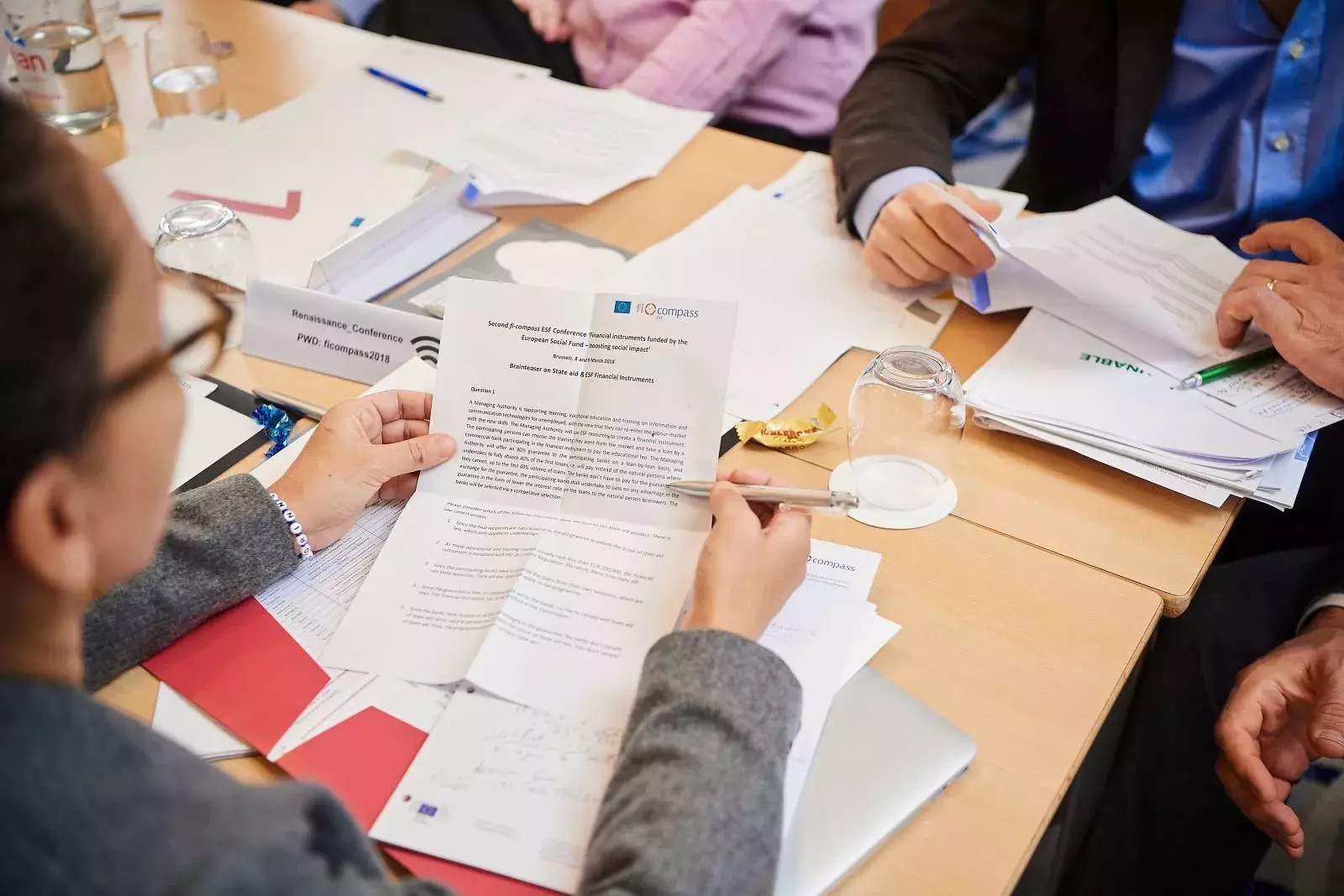 Participants working in groups on brainteasers