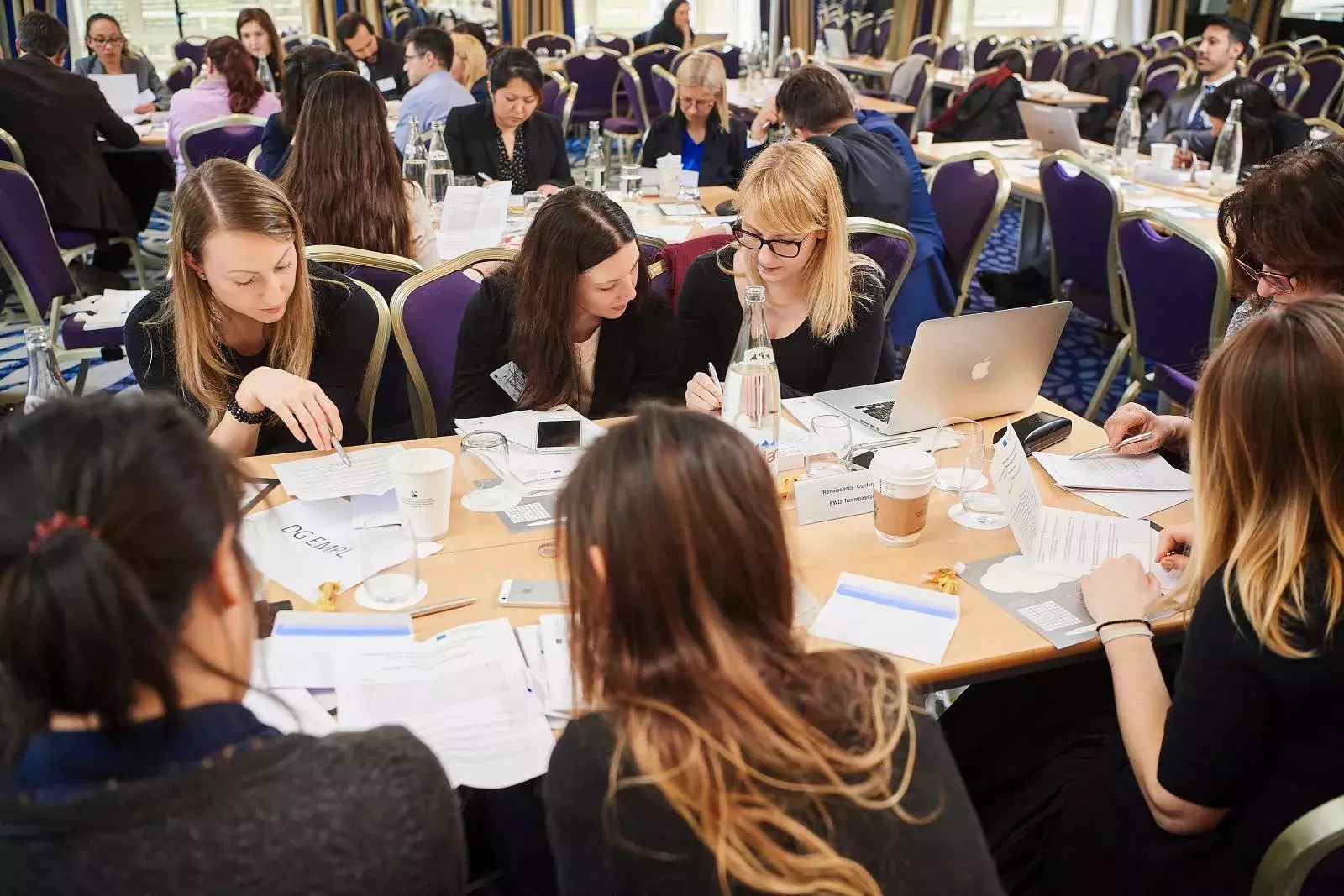 Participants working in groups on brainteasers