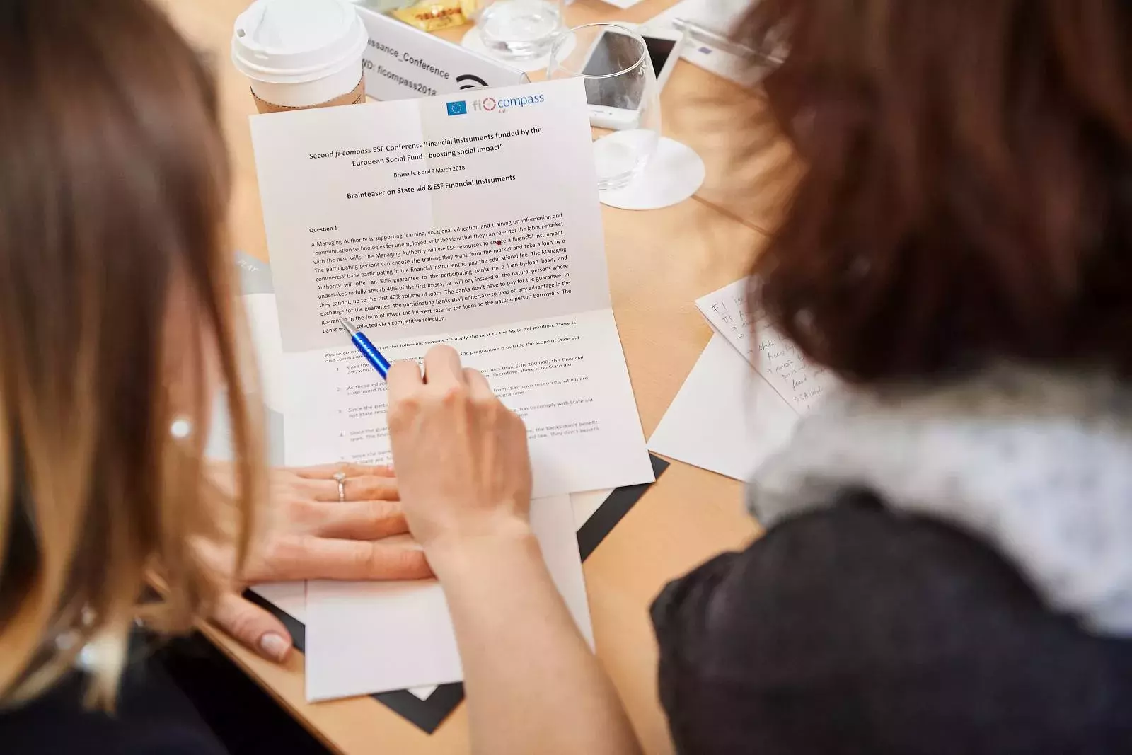 Participants working in groups on brainteasers