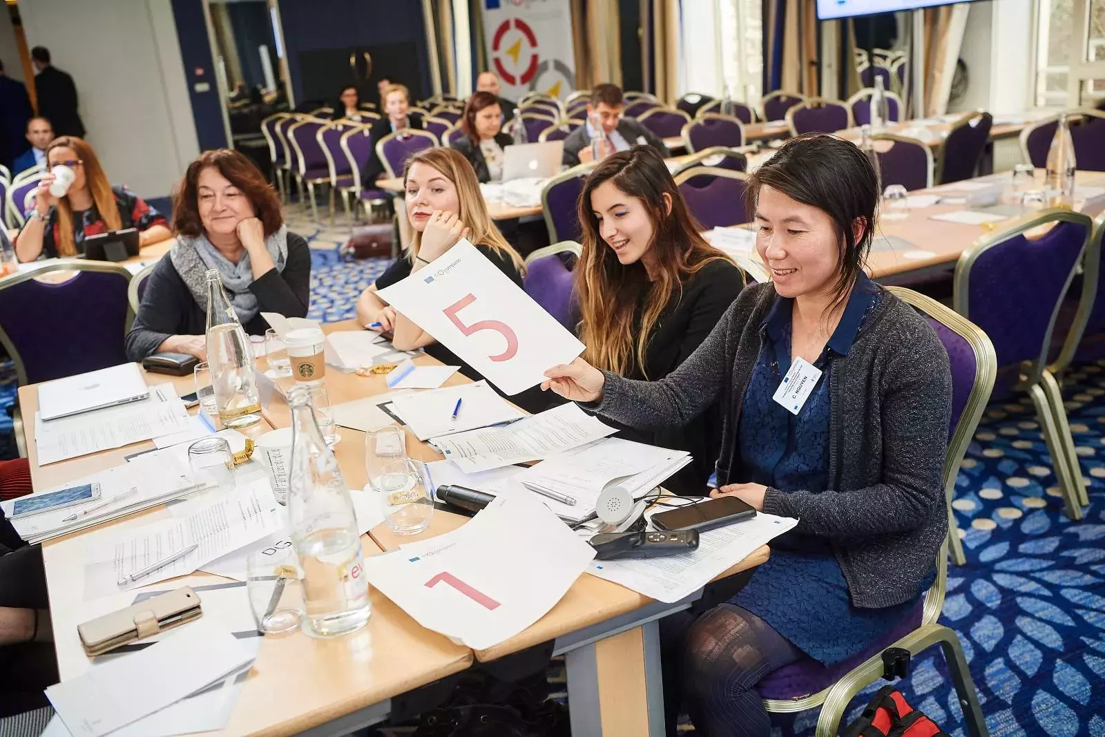 Participants working in groups on brainteasers