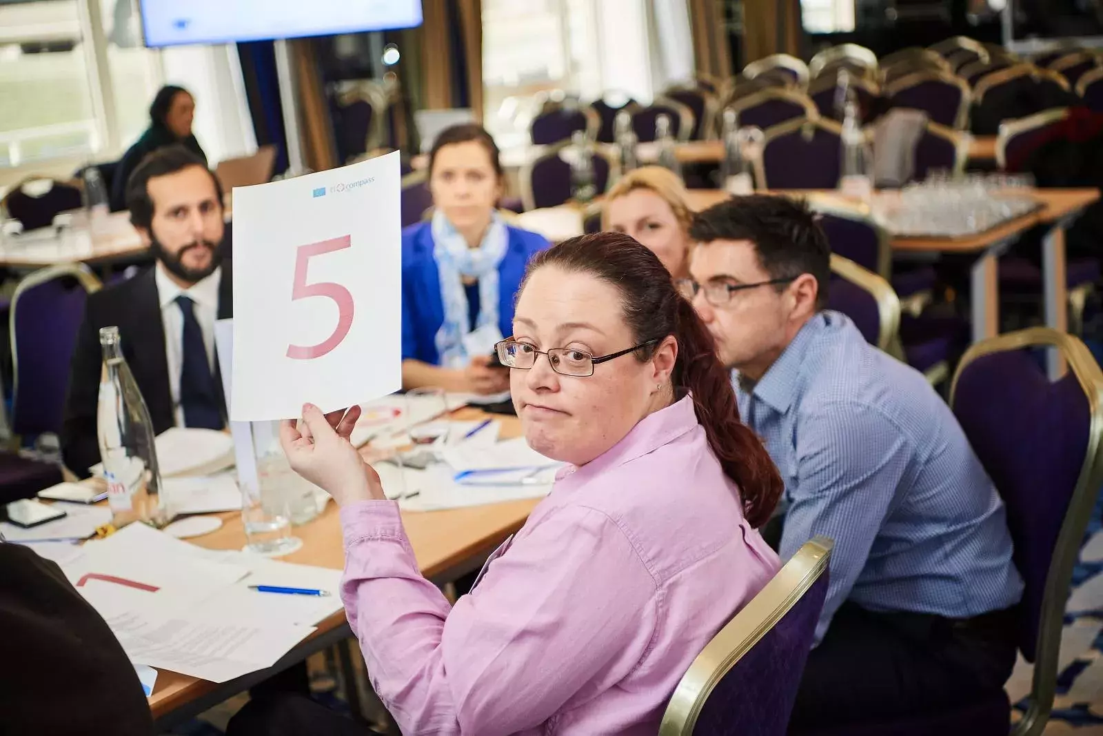 Participants working in groups on brainteasers