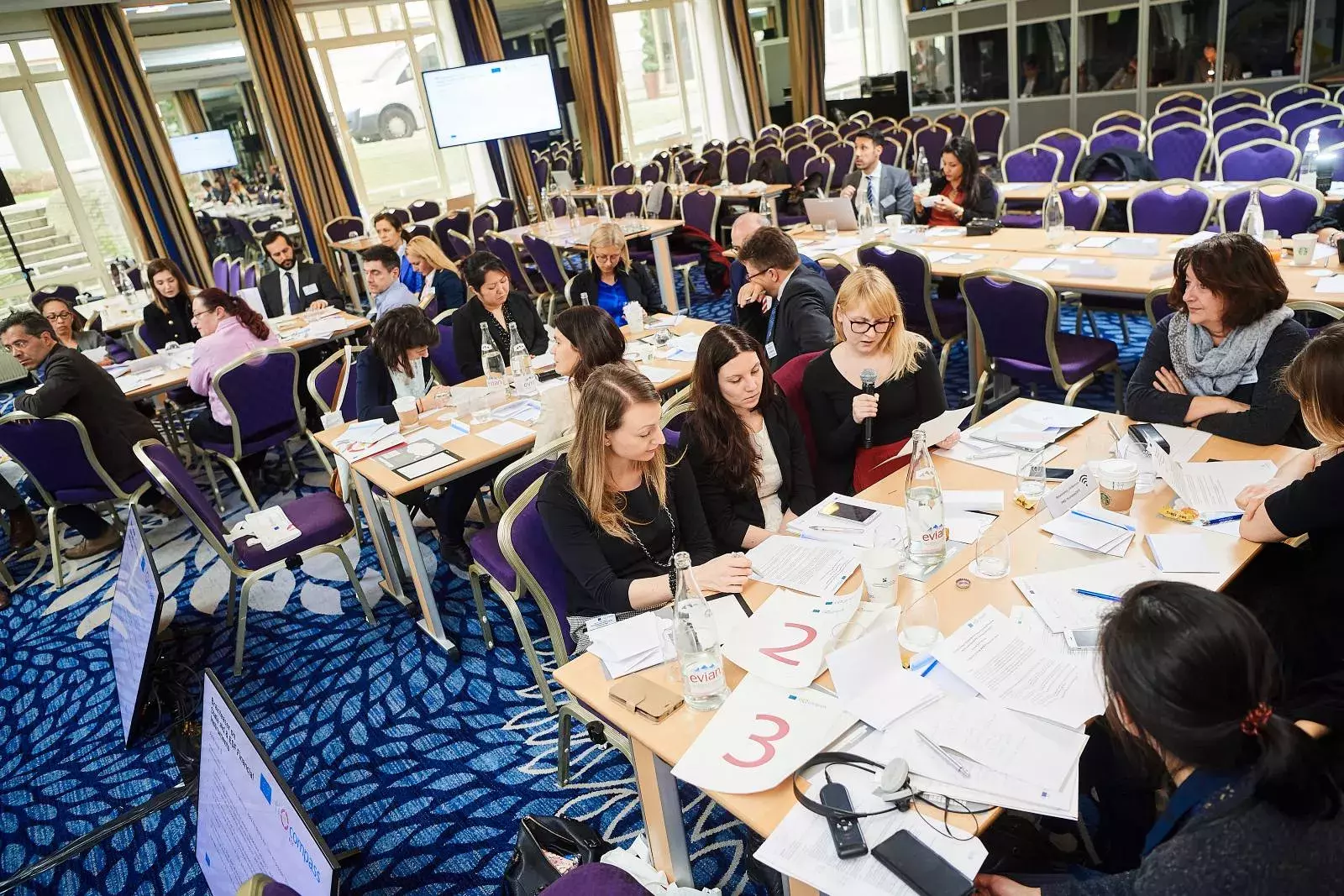 Participants working in groups on brainteasers