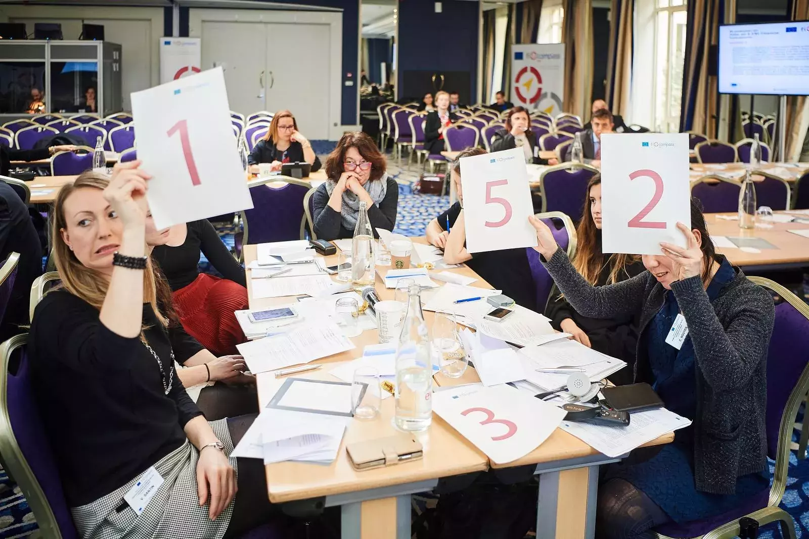 Participants working in groups on brainteasers