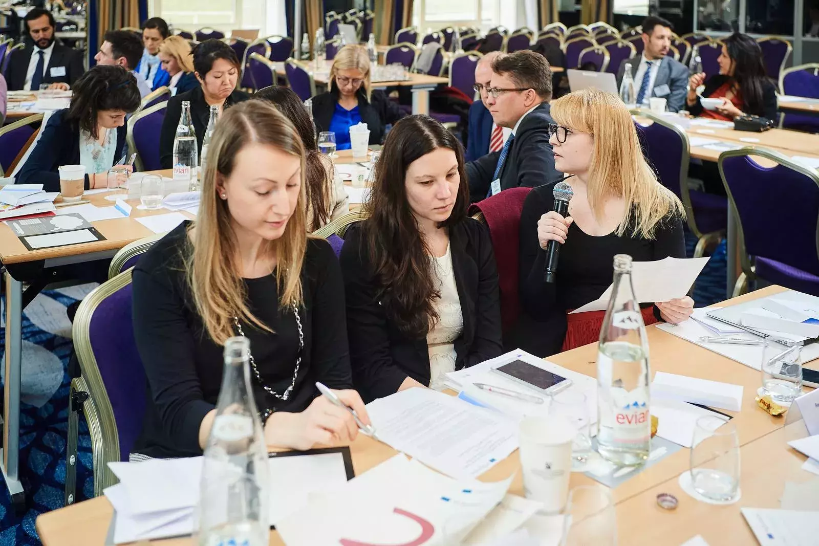 Participants working in groups on brainteasers