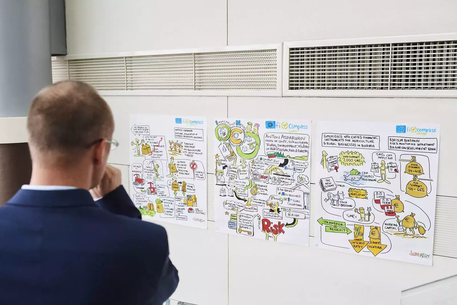 Event participant taking a look at illustrations