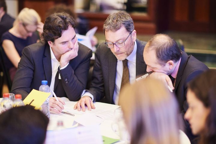 Participants working in groups on brain teasers