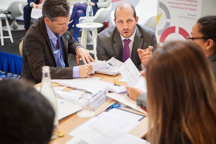 Participants working in groups on brainteasers