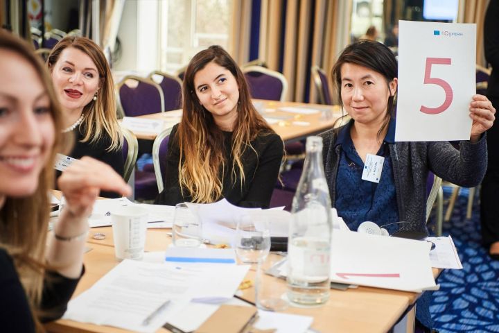 Participants working in groups on brainteasers
