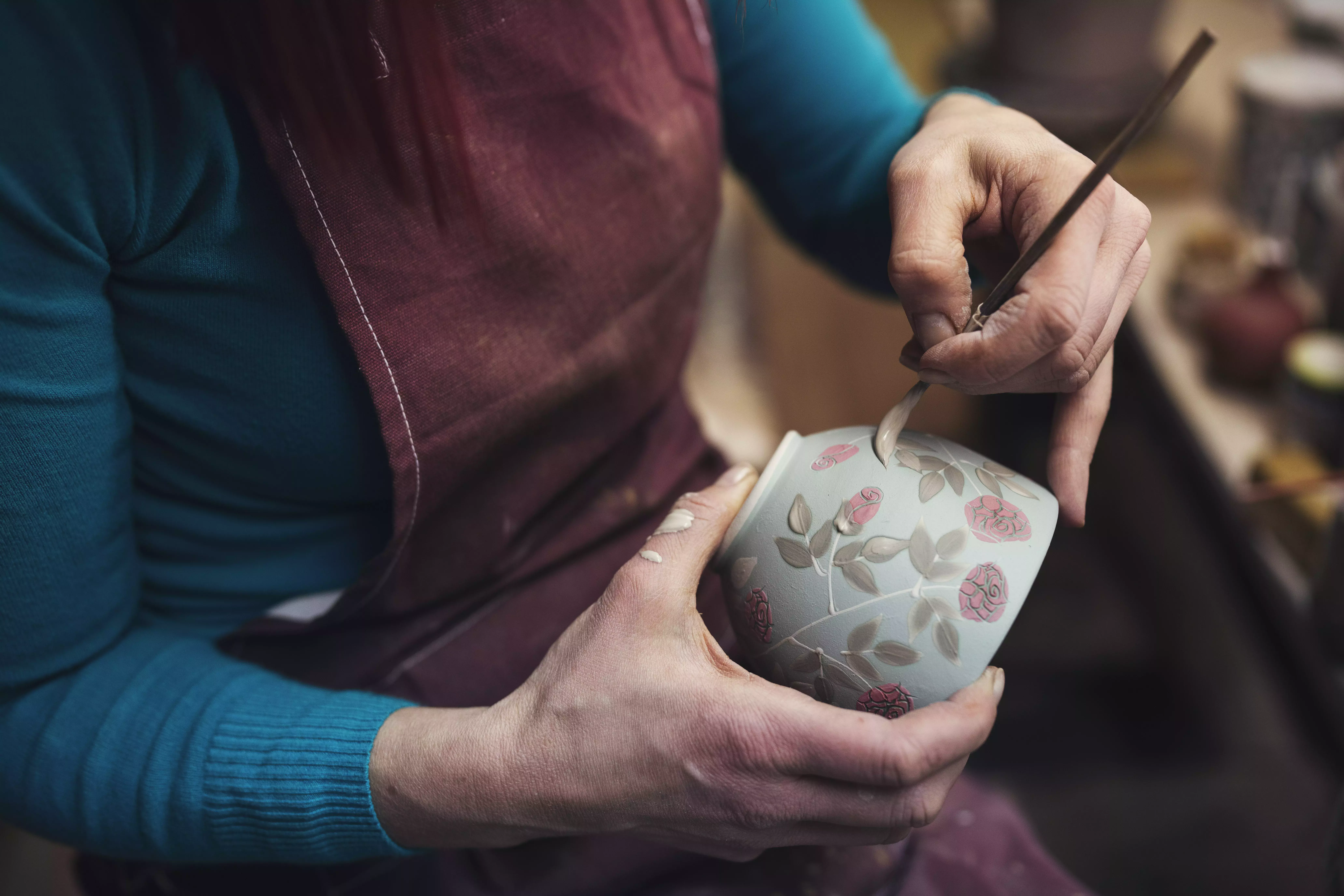 Woman painting pottery Woman painting pottery